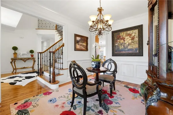 a living room with furniture and a chandelier
