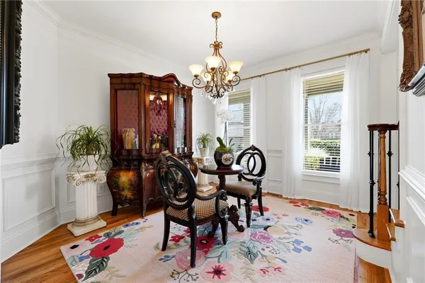 a dining room with furniture window and wooden floor