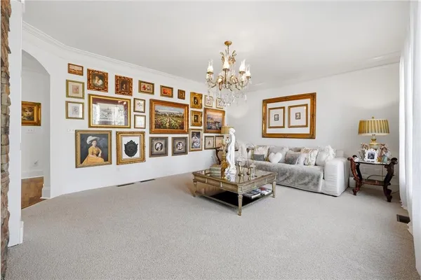 a view of a dining room with furniture and chandelier