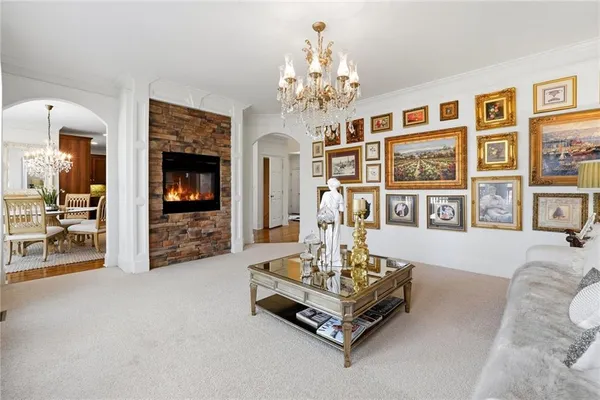 a kitchen with stainless steel appliances granite countertop a refrigerator a sink dishwasher a stove and a dining table with wooden floor