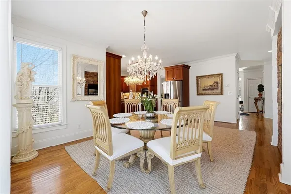 a kitchen with kitchen island granite countertop a sink refrigerator and cabinets