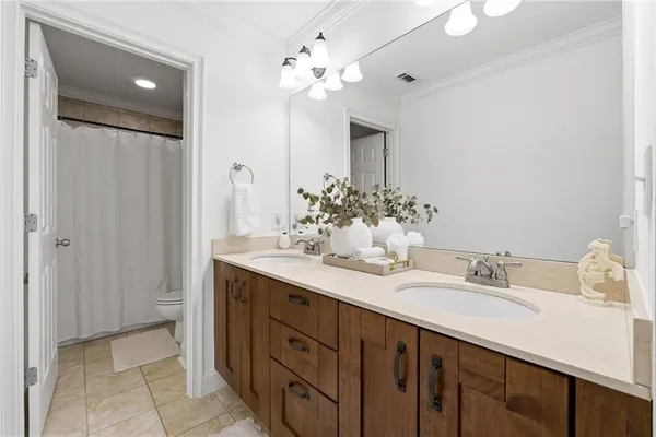 a spacious bedroom with a bed and a chandelier