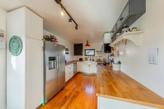 a kitchen with stainless steel appliances a stove sink microwave and cabinets