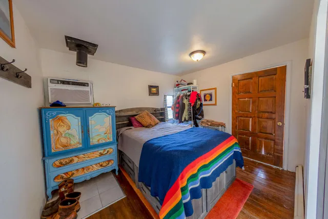 a bedroom with a bed and a desk