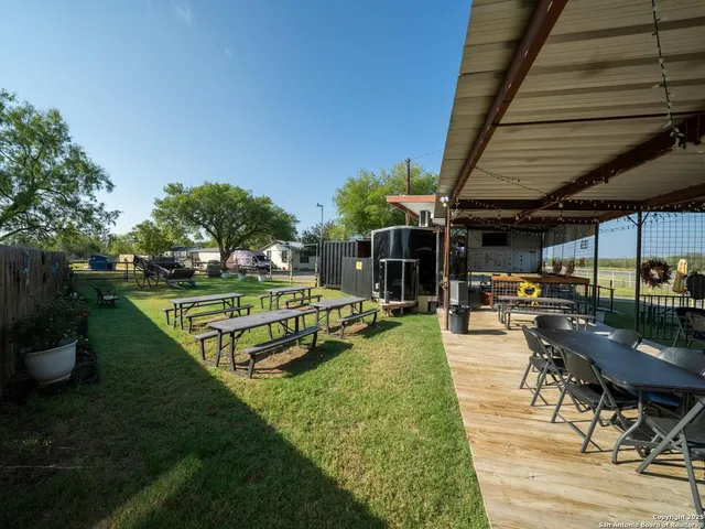 a view of a backyard with sitting area