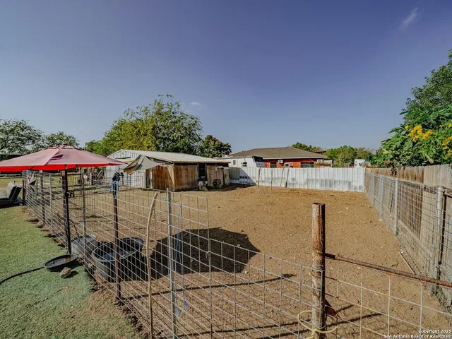 a view of yard with swimming pool and sitting area