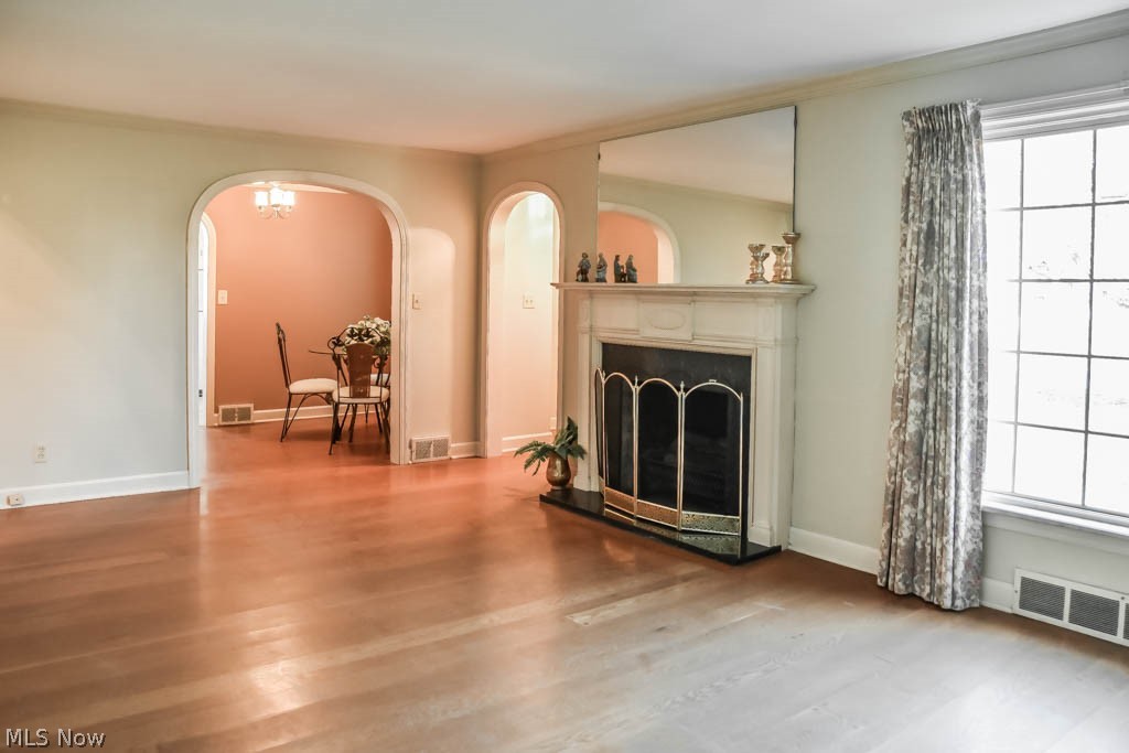 1553 Broad Avenue Northwest Canton, OH 44708 - Photo 2 of 20 Spacious living room with a fireplace and archways.