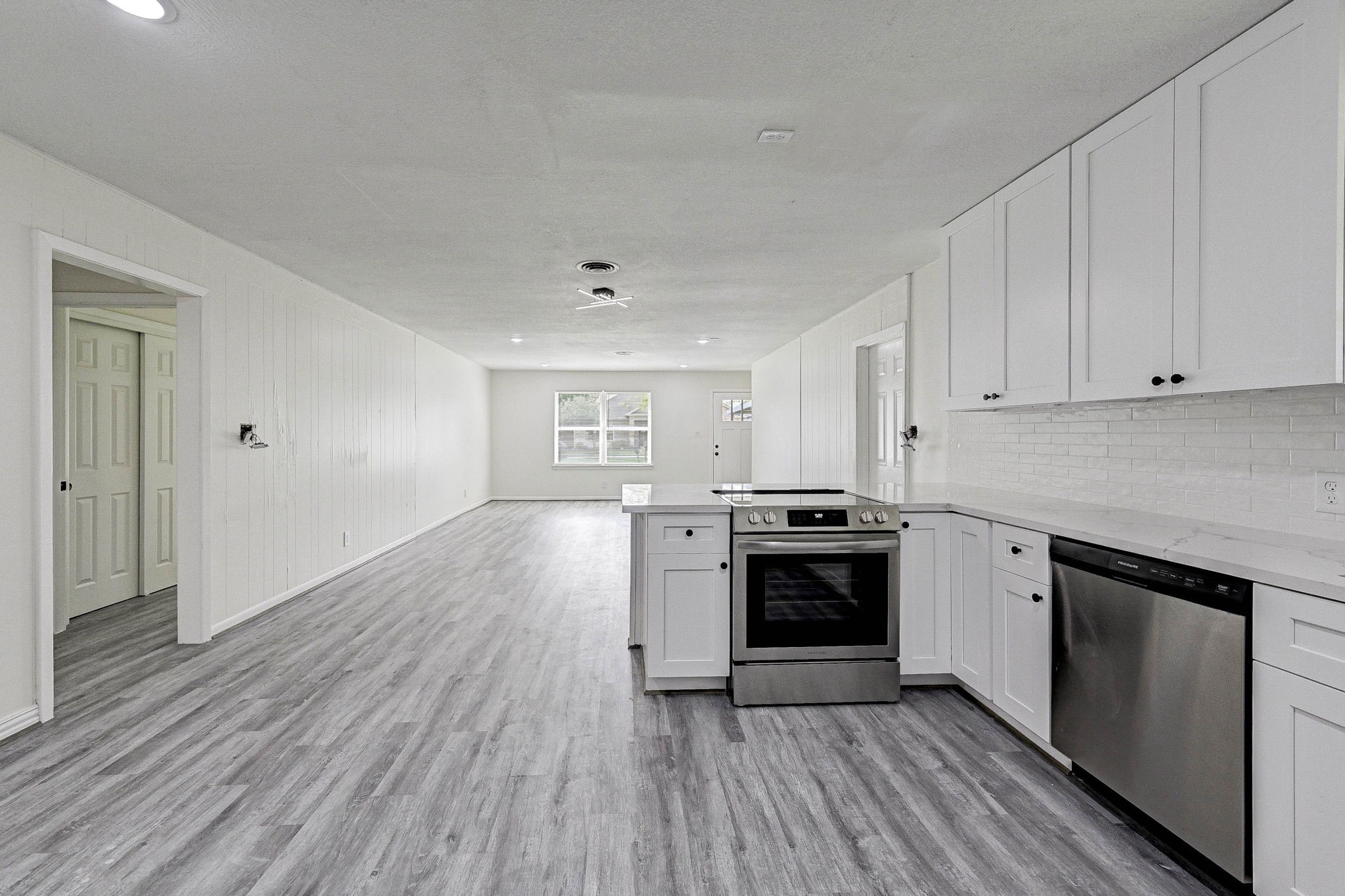 6027 Ledbetter Street Houston, TX 77087 - Photo 11 of 23 a kitchen with wooden floors and stainless steel appliances