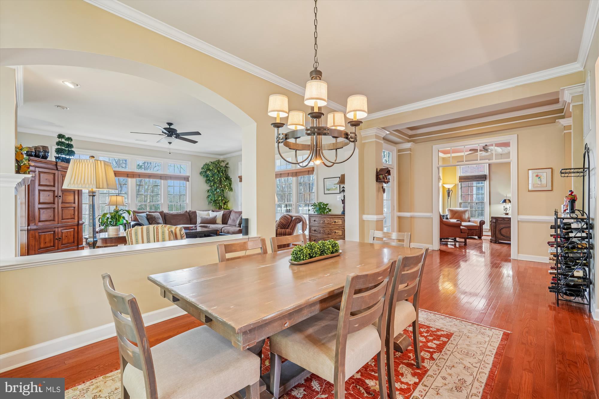 111 Lake Street Gaithersburg, MD 20878 - Photo 14 of 77 a dining room with wooden floor a chandelier a wooden table and chairs
