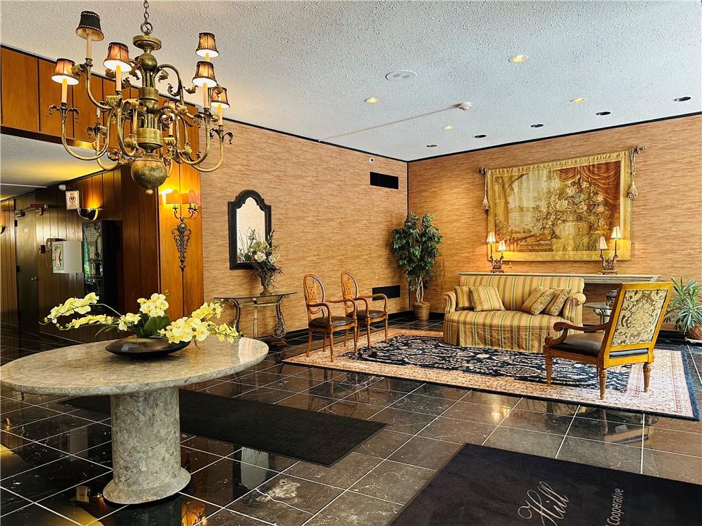 1150 Bower Hill Road, Unit 718B Mt. Lebanon, PA 15243 - Photo 3 of 21 a room with lots of wooden furniture and large windows