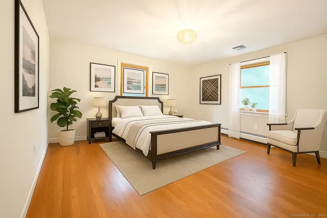 a bed room with a bed and a potted plant