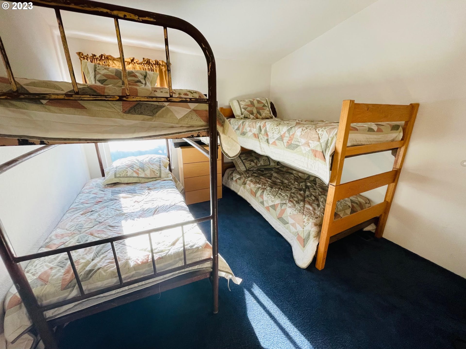 425 Bernard Lane Chemult, OR 97731 - Photo 16 of 32 a bed sitting in a bedroom next to a window