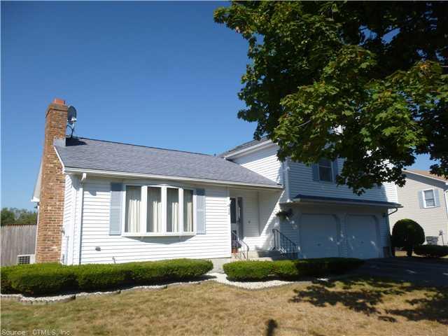 32 Spruceland Road Enfield, CT 06082 - Photo 1 of 1 a front view of a house with a garden and tree
