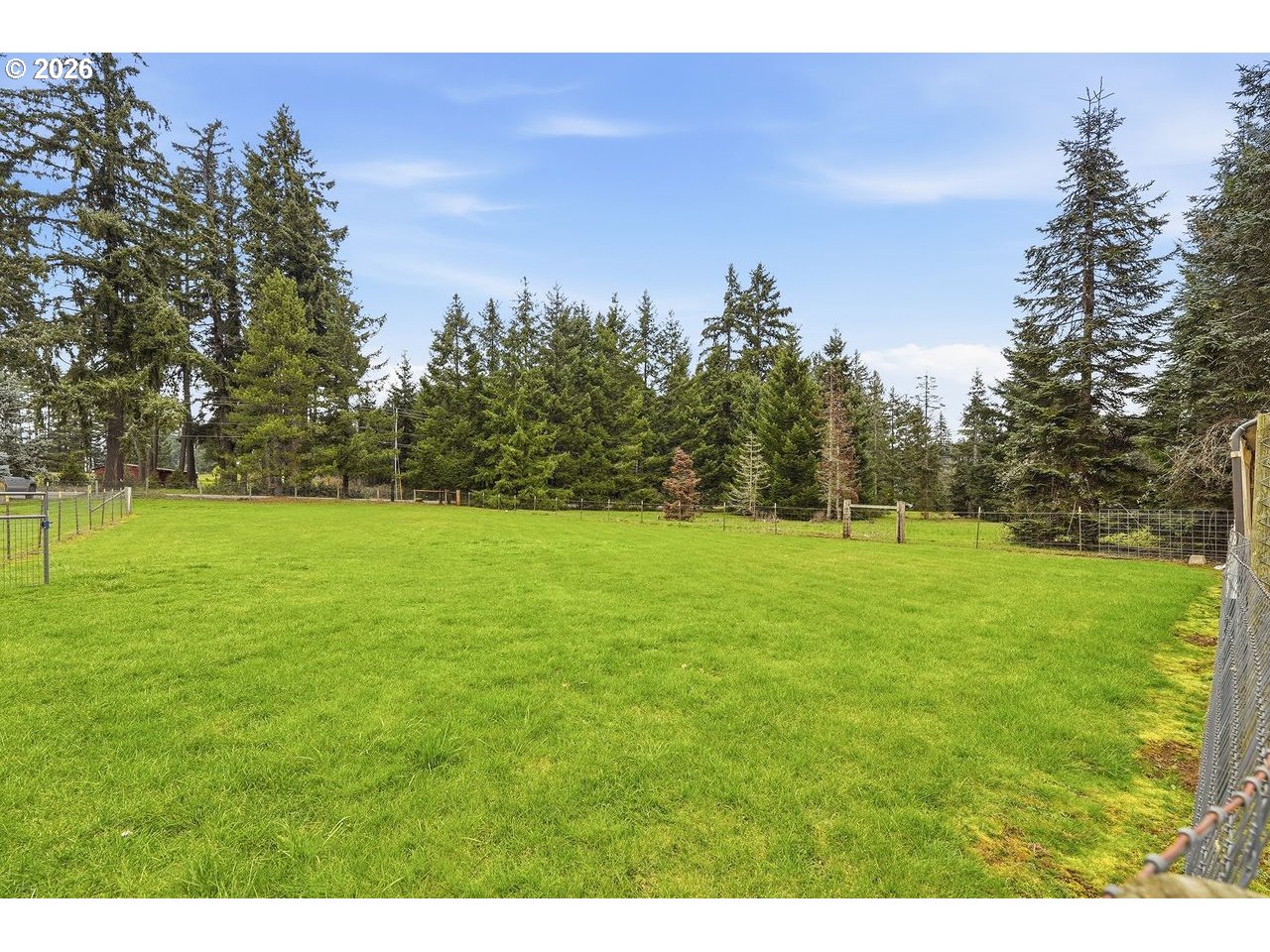 20044 South Fischers Mill Road Oregon City, OR 97045 - Photo 37 of 48 a view of a green field with trees in the background