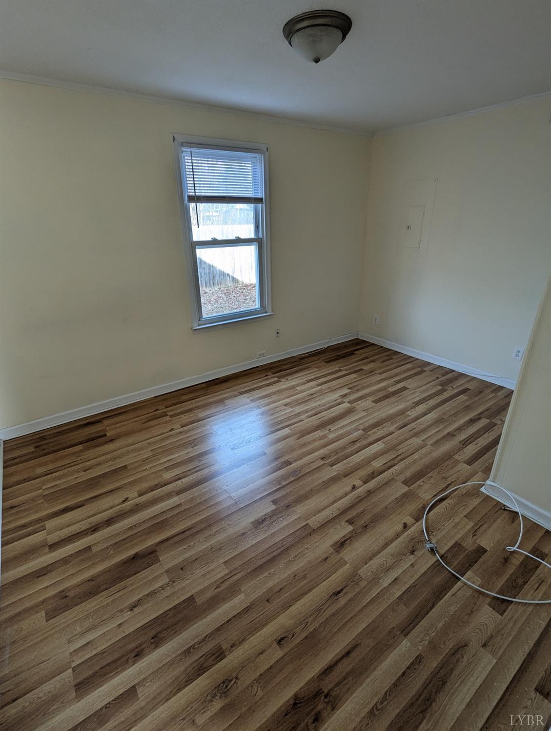 302 Prospect Road Hurt, VA 24563 - Photo 7 of 9 an empty room with wooden floor cabinet and windows