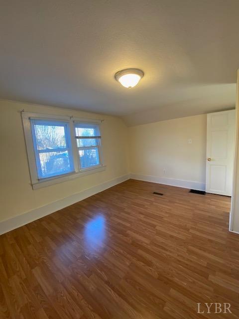 302 Prospect Road Hurt, VA 24563 - Photo 8 of 9 an empty room with wooden floor and windows