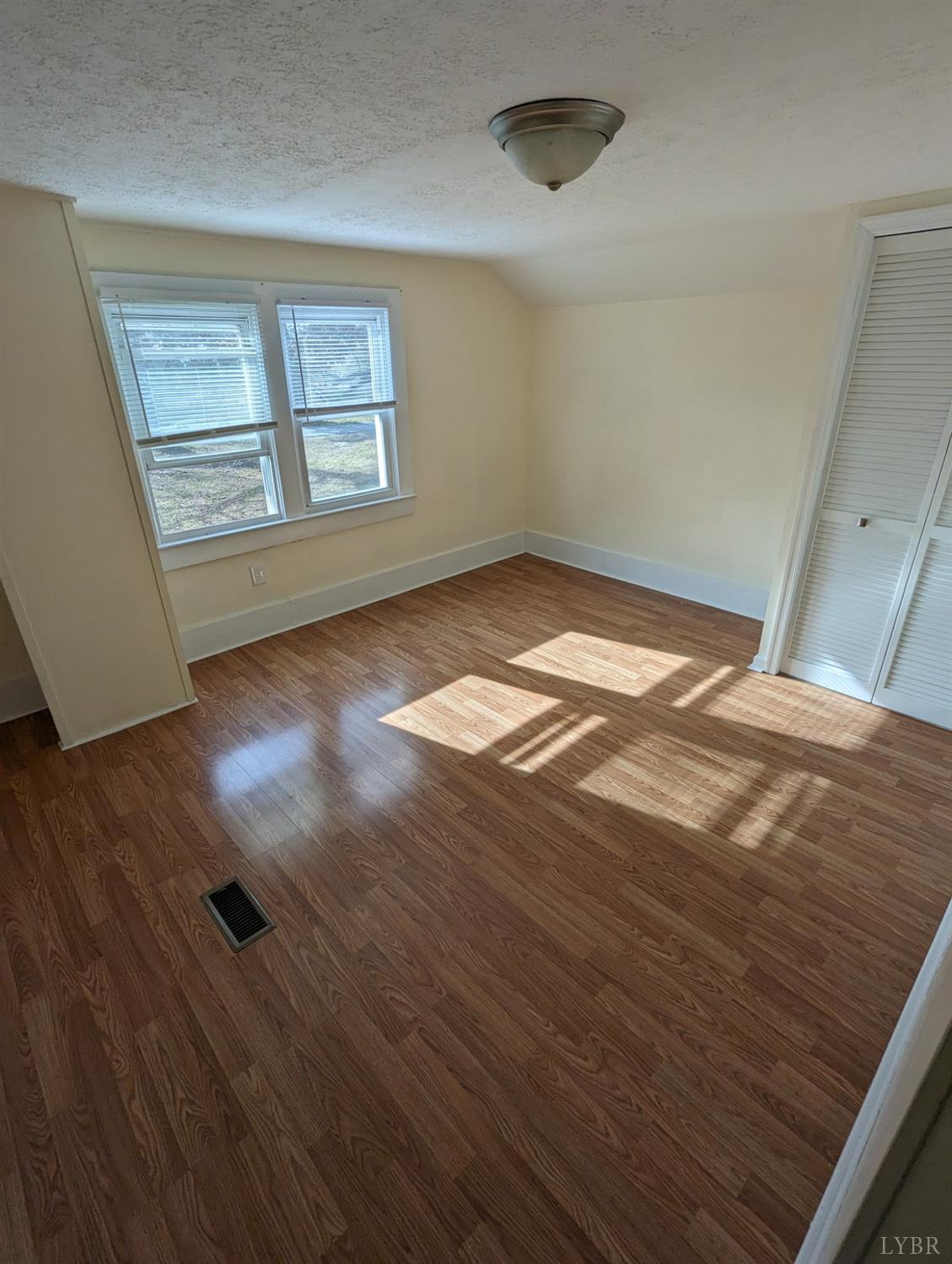 302 Prospect Road Hurt, VA 24563 - Photo 9 of 9 wooden floor in an empty room with a window