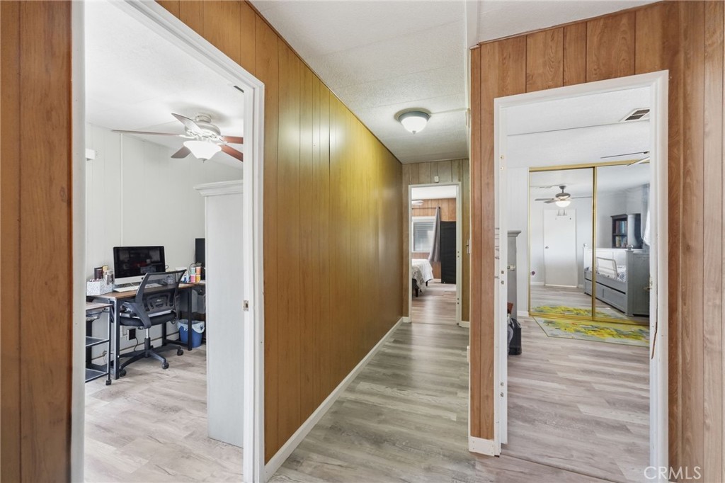 15181 Van Buren Boulevard, Unit 85 Riverside, CA 92504 - Photo 15 of 54 a view of a hallway with a livingroom view and a bathroom