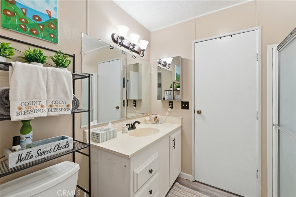 15181 Van Buren Boulevard, Unit 85 Riverside, CA 92504 - Photo 18 of 54 a bathroom with a sink a mirror and a shower