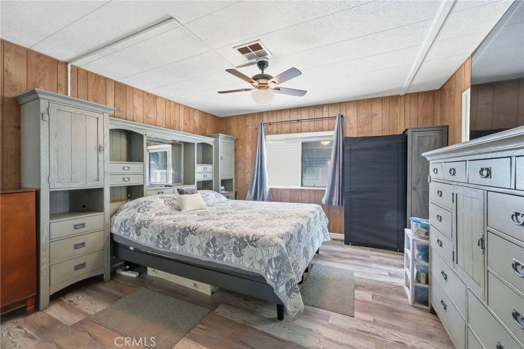 15181 Van Buren Boulevard, Unit 85 Riverside, CA 92504 - Photo 19 of 54 a spacious bedroom with a bed dresser and a window