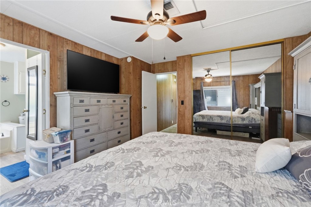 15181 Van Buren Boulevard, Unit 85 Riverside, CA 92504 - Photo 20 of 54 a bedroom with a bed and a flat screen tv