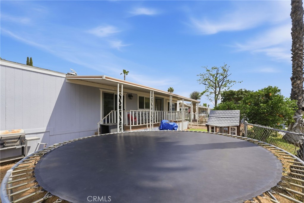 15181 Van Buren Boulevard, Unit 85 Riverside, CA 92504 - Photo 22 of 54 a view of outdoor space yard deck and house