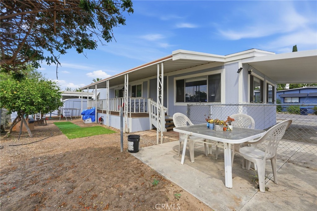 15181 Van Buren Boulevard, Unit 85 Riverside, CA 92504 - Photo 23 of 54 a backyard of a house with barbeque oven table and chairs