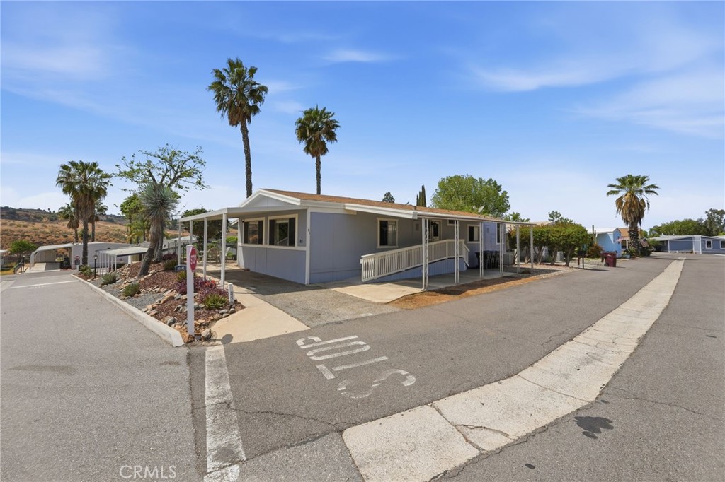 15181 Van Buren Boulevard, Unit 85 Riverside, CA 92504 - Photo 27 of 54 a front view of a house with a yard