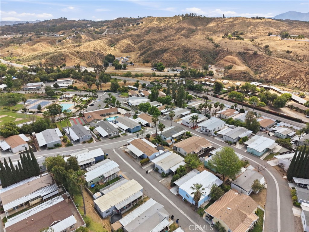 15181 Van Buren Boulevard, Unit 85 Riverside, CA 92504 - Photo 29 of 54 an aerial view of residential house with parking