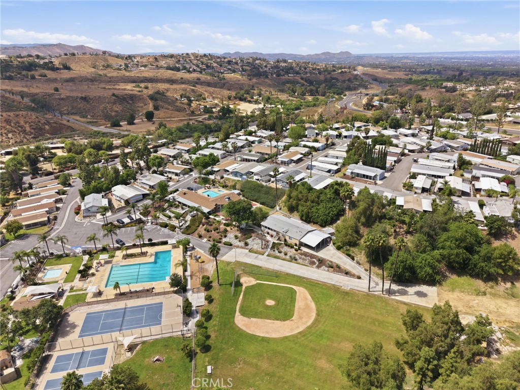 15181 Van Buren Boulevard, Unit 85 Riverside, CA 92504 - Photo 30 of 54 an aerial view of residential houses with outdoor space
