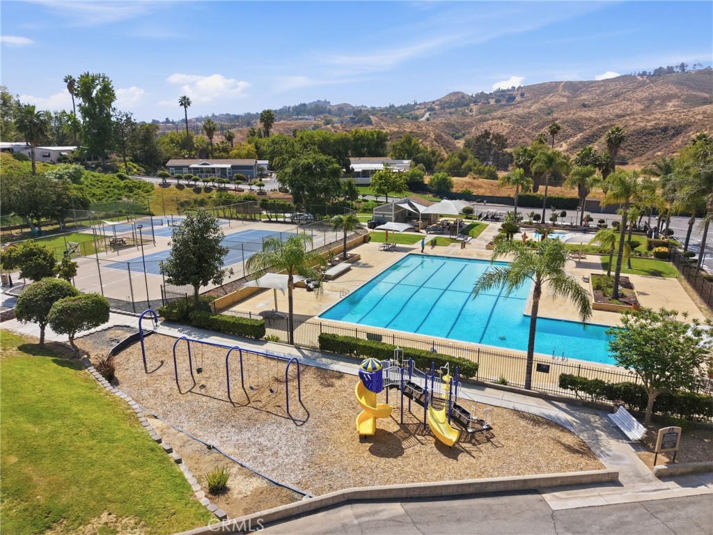 15181 Van Buren Boulevard, Unit 85 Riverside, CA 92504 - Photo 34 of 54 a view of a swimming pool with a lounge chairs