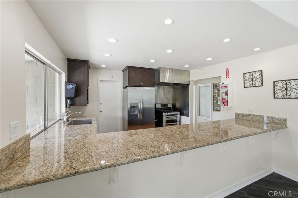 15181 Van Buren Boulevard, Unit 85 Riverside, CA 92504 - Photo 49 of 54 a kitchen with stainless steel appliances granite countertop a sink a stove and a refrigerator