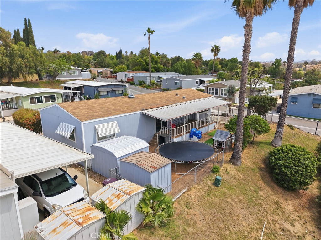 15181 Van Buren Boulevard, Unit 85 Riverside, CA 92504 - Photo 5 of 54 a view of a patio with table and chairs with wooden floor and fence