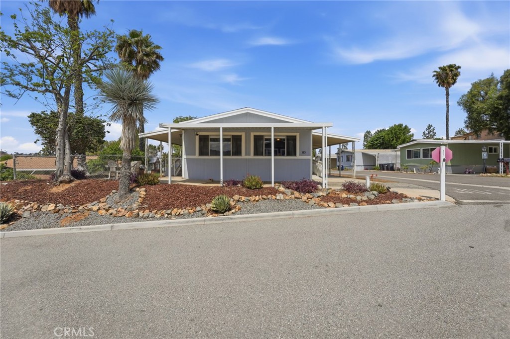 15181 Van Buren Boulevard, Unit 85 Riverside, CA 92504 - Photo 51 of 54 a front view of a house with a yard
