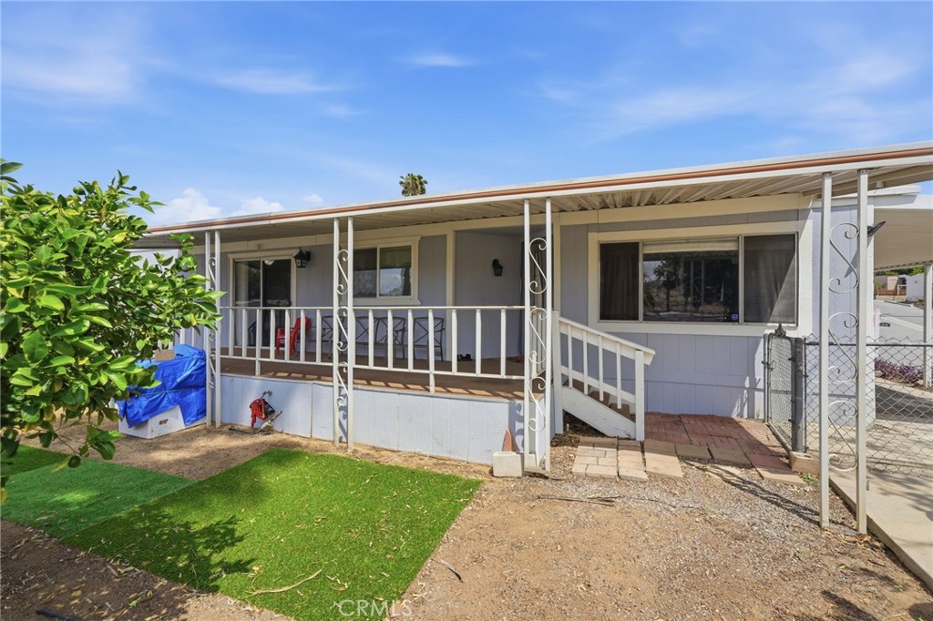 15181 Van Buren Boulevard, Unit 85 Riverside, CA 92504 - Photo 7 of 54 a view of a house with backyard porch and sitting area