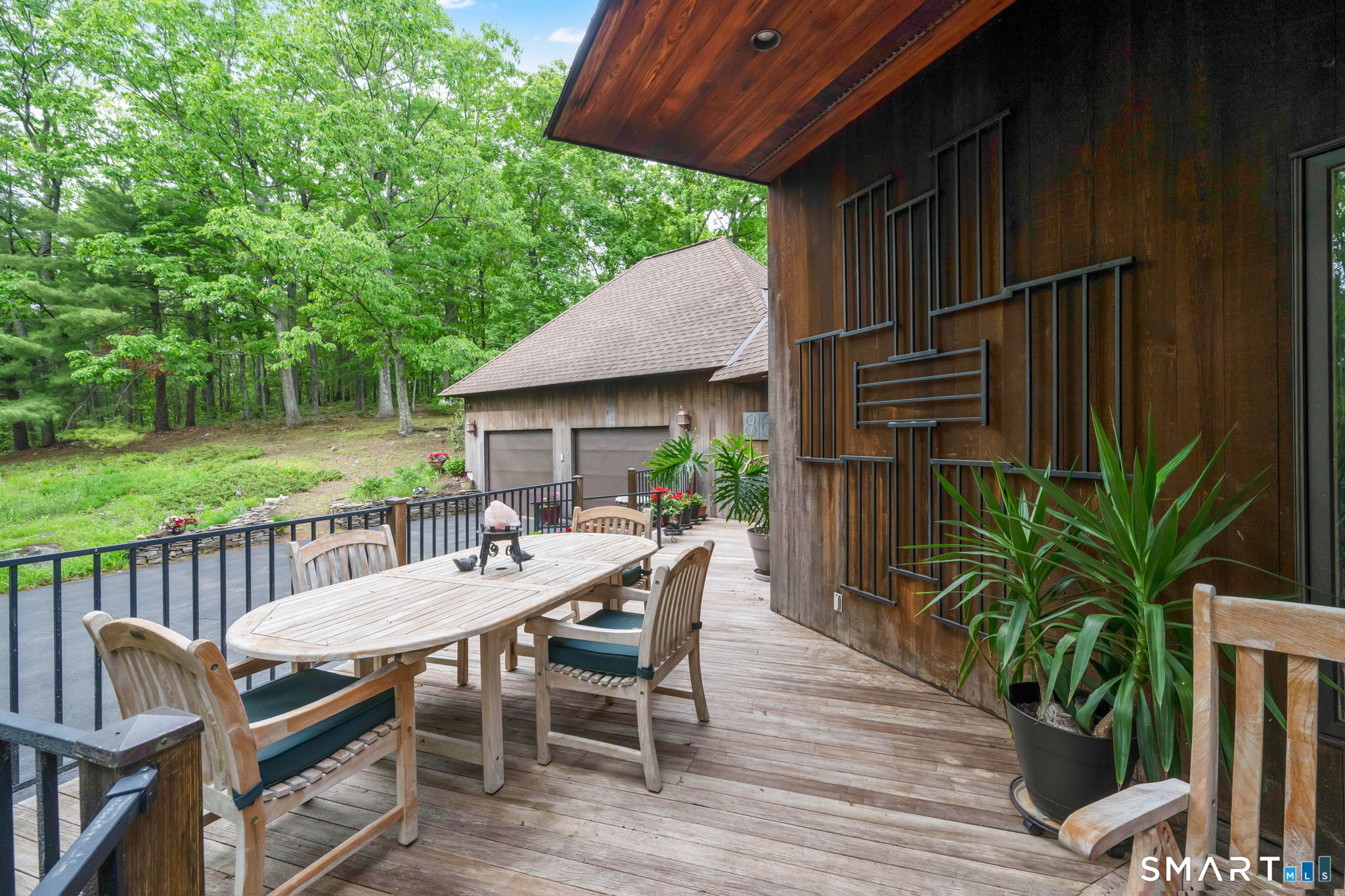 86 Washburn Road Canton, CT 06019 - Photo 38 of 40 a view of a patio with table and chairs potted plants with wooden floor