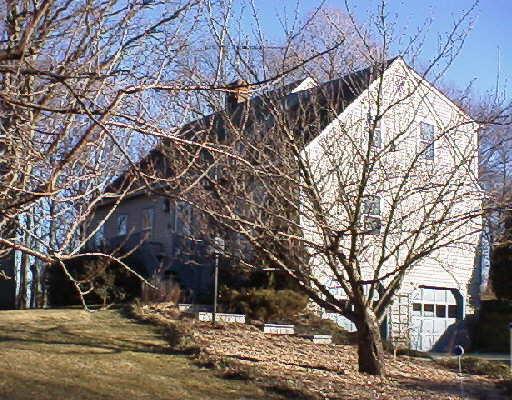 7 West Farm Ridge Road Newtown, CT 06470 - Photo 1 of 1 a view of a wooden house with a snow on the road