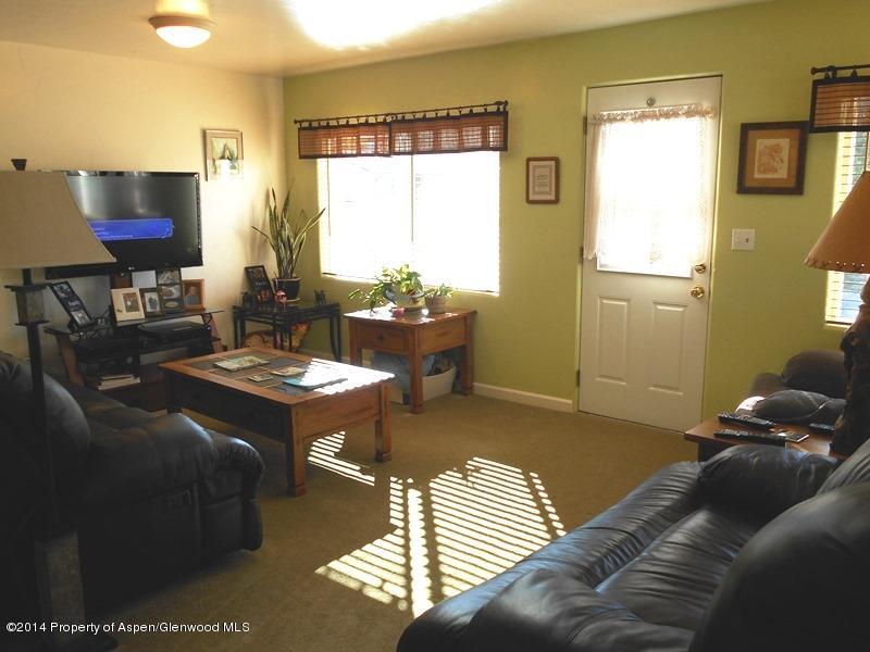 440 East 7th Street Rifle, CO 81650 - Photo 3 of 11 a living room with furniture and a flat screen tv