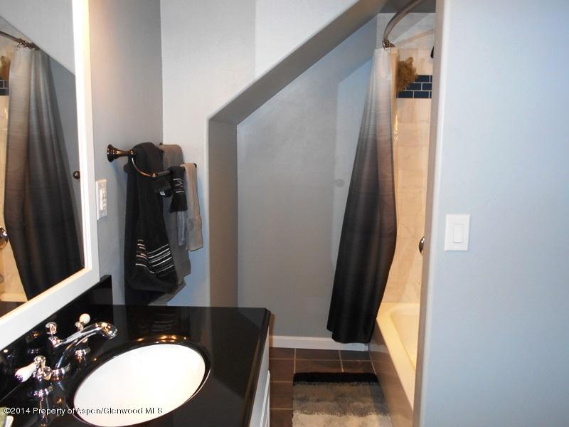 440 East 7th Street Rifle, CO 81650 - Photo 8 of 11 a bathroom with a sink and a mirror