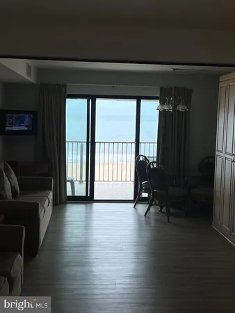 a view of a room with furniture and a floor to ceiling window