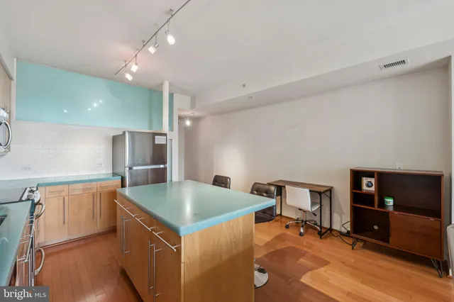 a kitchen with stainless steel appliances granite countertop a sink a stove and a refrigerator