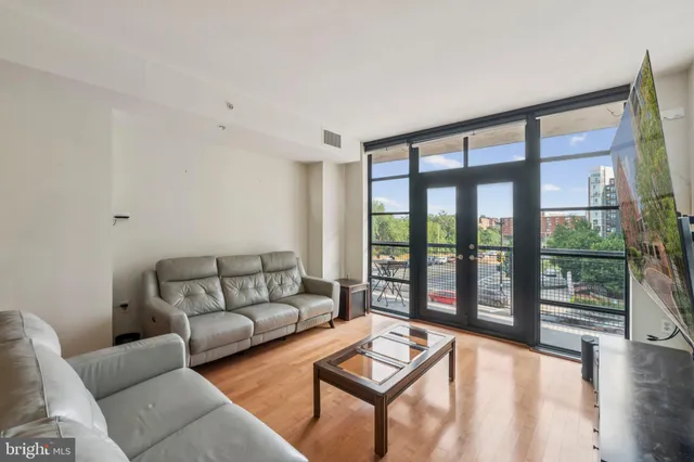 a living room with furniture and a large window
