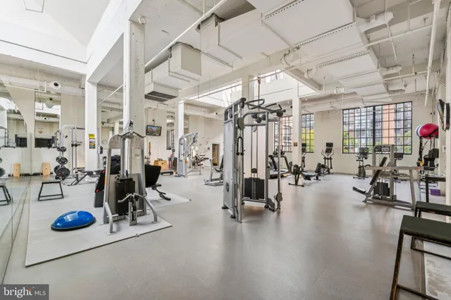 a view of a room with lots of gym equipment