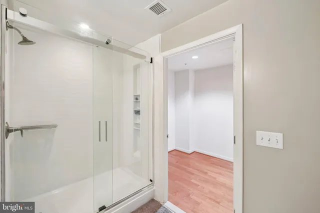 a bathroom with a shower and a glass door