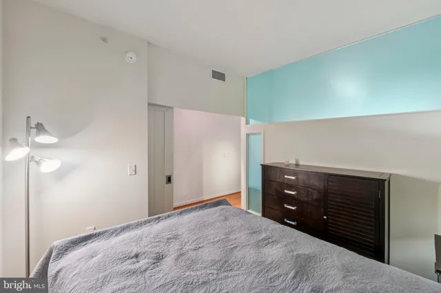 a bedroom with a bed and a dresser