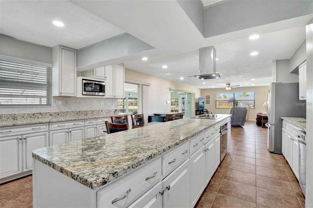 250 Bangsberg Road Southeast Port Charlotte, FL 33952 - Photo 7 of 59 a large kitchen with kitchen island granite countertop a large counter top and appliances
