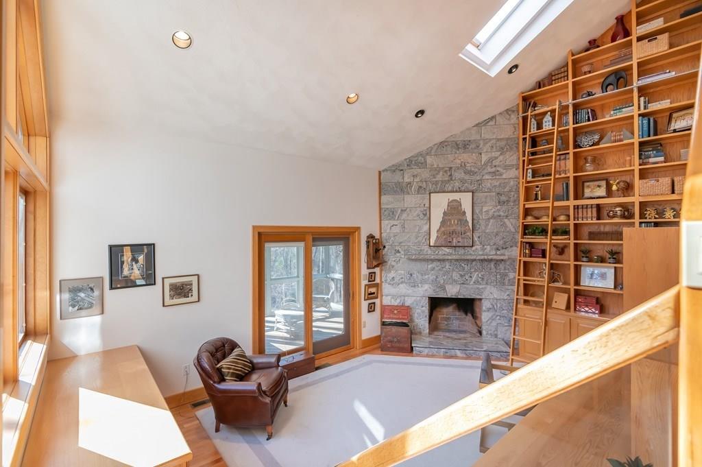 8 Cameron Road Andover, MA 01810 - Photo 13 of 42 a living room with furniture a flat screen tv and a fireplace