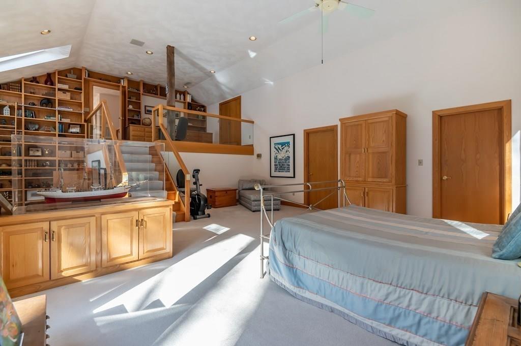 8 Cameron Road Andover, MA 01810 - Photo 37 of 42 a spacious bedroom with a large bed a chandelier and dresser