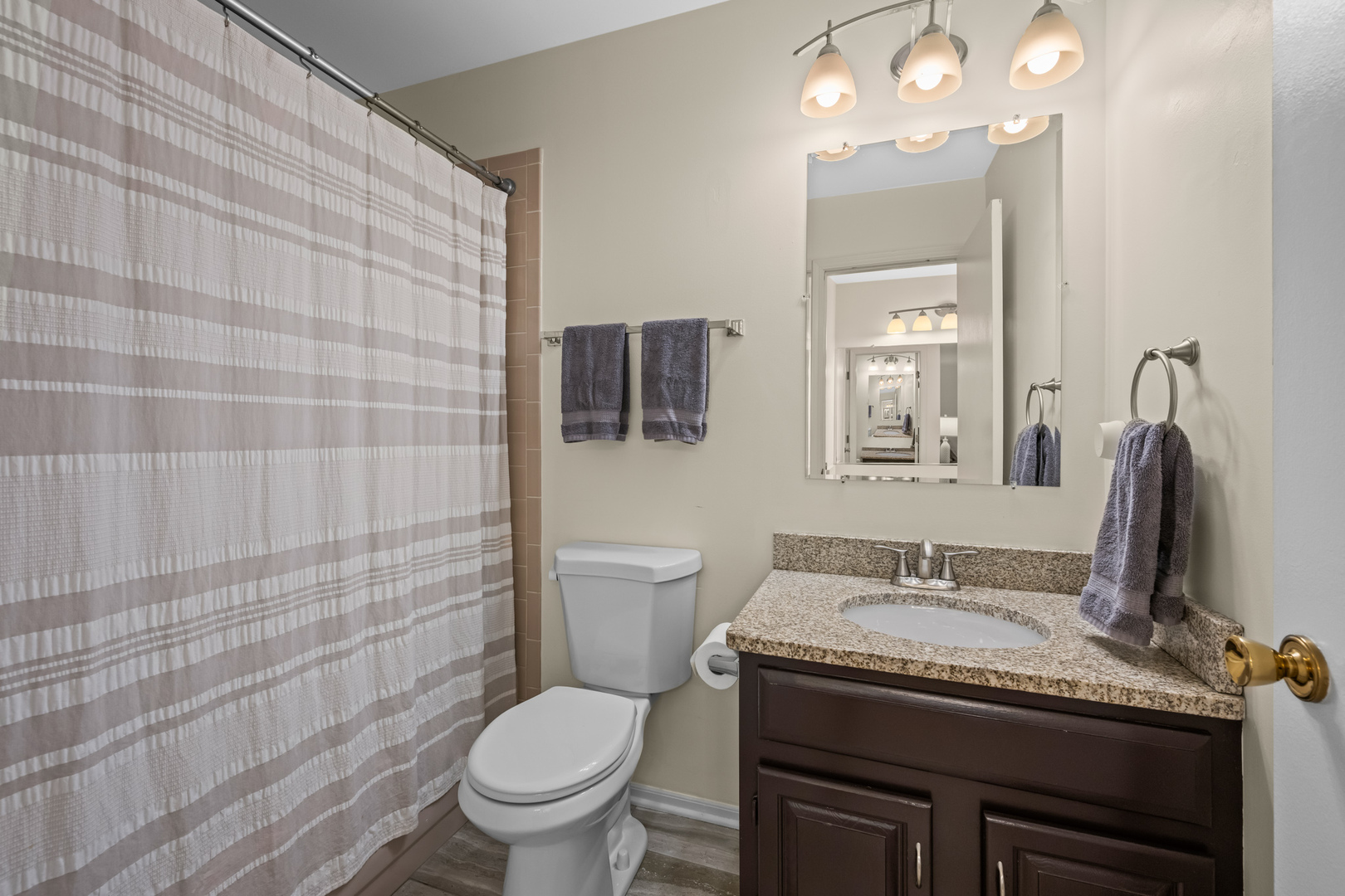 S579 Robbins Street Winfield, IL 60190 - Photo 19 of 36 a bathroom with a granite countertop toilet sink and mirror