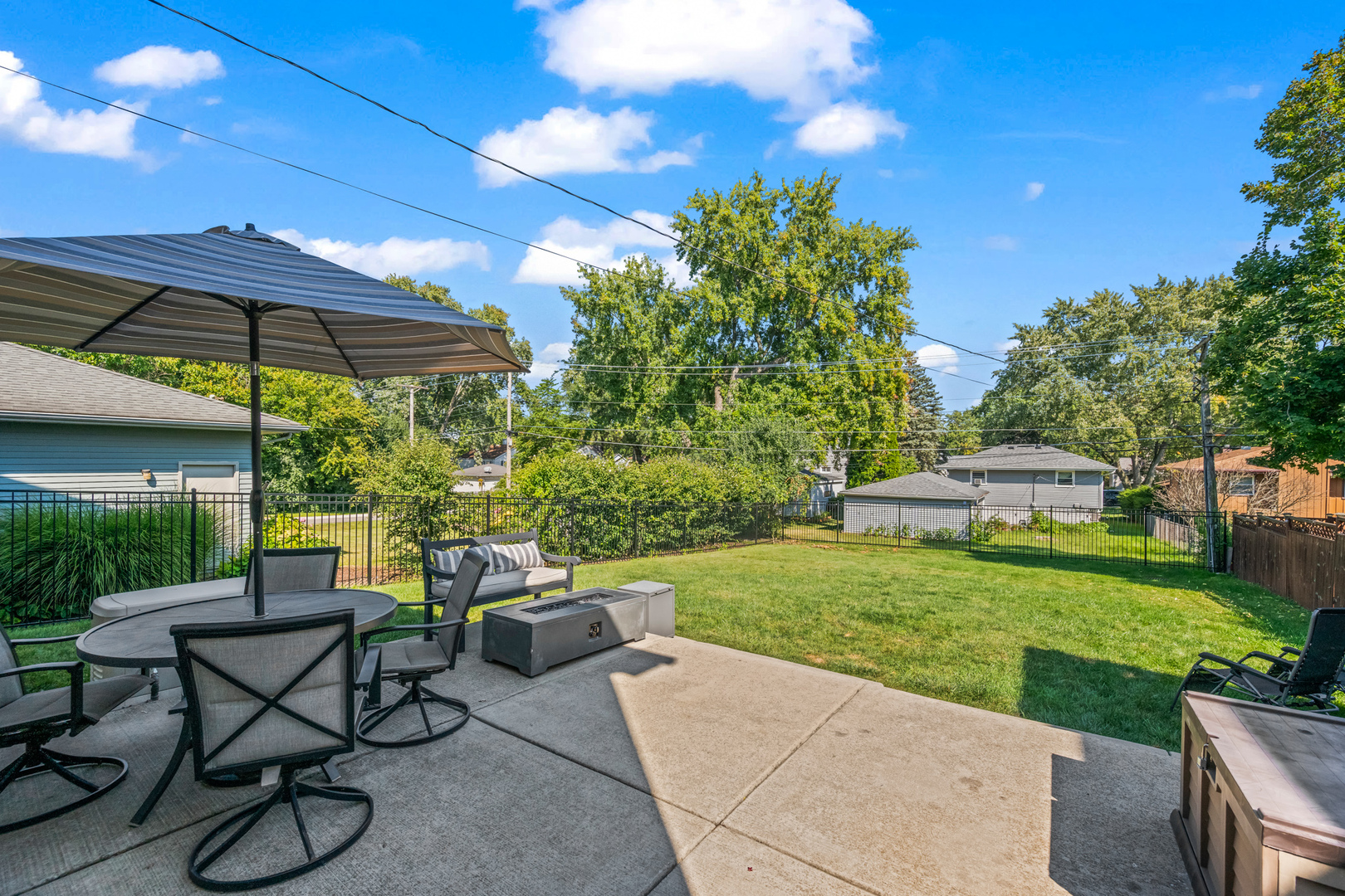 S579 Robbins Street Winfield, IL 60190 - Photo 27 of 36 a view of a patio with table and chairs under an umbrella